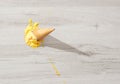 Ice cream in a waffle cone fell on floor Royalty Free Stock Photo
