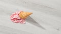 Ice cream in a waffle cone fell on floor Royalty Free Stock Photo