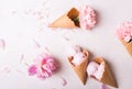 Ice cream in a waffle cone on a light background. Strawberry ice cream. Flowers in a waffle cone. Pink carnations. Flowers on a wo Royalty Free Stock Photo