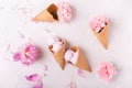 Ice cream in a waffle cone on a light background. Strawberry ice cream. Flowers in a waffle cone. Pink carnations. Flowers on a wo Royalty Free Stock Photo