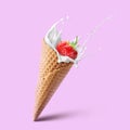 Ice cream waffle cone with milk splash and strawberry isolated on pink Royalty Free Stock Photo
