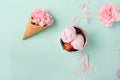 Ice cream in a waffle cone on a turquoise background. Strawberry ice cream. Flowers in a waffle cone. Pink carnations. Royalty Free Stock Photo