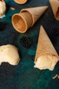 Ice cream in waffle cones conceals vanilla in the background with berries Royalty Free Stock Photo