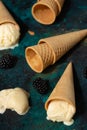 Ice cream in waffle cones conceals vanilla in the background with berries Royalty Free Stock Photo