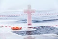 Ice cross and hole in winter pond on Epiphany Royalty Free Stock Photo