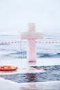 Ice cross and hole in winter pond on Epiphany Royalty Free Stock Photo
