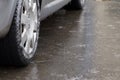 Ice crusted ground, car wheel on icy road, hazardous weather conditions Royalty Free Stock Photo