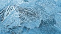 Ice crystals close up on a window glass. Mystical fabulous abstract pattern. Backdrop for winter, Christmas or New Year theme. Royalty Free Stock Photo