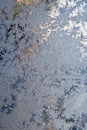 Ice crystals close-up on a window pane. Vertical wallpaper for winter and New Year theme. Translucent blue and white background. Royalty Free Stock Photo