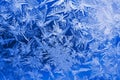 Ice crystals close up on a window pane in winter. Dark blue and white background or wallpaper. Mystical fabulous abstract lase. Royalty Free Stock Photo