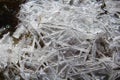 Ice crystals formed on the edge of running water with a black background Royalty Free Stock Photo