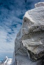 Ice crystals formed on rockface in winter against cloud sky Royalty Free Stock Photo