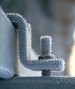 Ice crystals on frozen nut and bolt in winter