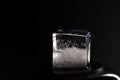 Ice cube on black background. Low key photo Royalty Free Stock Photo