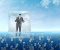 Ice cube with a businessman floating in the sea