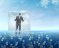 Ice cube with a businessman floating in the sea Royalty Free Stock Photo