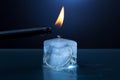 Ice cube candle is lit Royalty Free Stock Photo