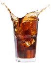 Ice cube droped in cola glass and splashing