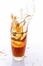 Ice cube droped in cola glass Royalty Free Stock Photo