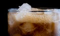 Ice cube in fizzy splashing water with soda Royalty Free Stock Photo