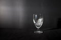 Ice cube melting in wine glass isolated in black background