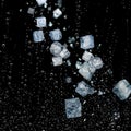 Ice cube and rain water drop falling isolated with black background Royalty Free Stock Photo