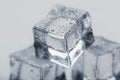 Ice cube with water drops close - up in macro on a white background. Refreshing ice. Isolate Royalty Free Stock Photo