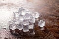 Ice cube on wooden table and light blurred background Royalty Free Stock Photo