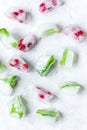 Ice cubes with berries and mint stone background top view Royalty Free Stock Photo