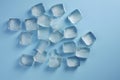 Ice cubes on blue background. Top view, flat lay. Close up. Generative AI Royalty Free Stock Photo
