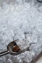 ice cubes in a bucket. ice shovel. Ice scoop on the ice cubes background, Top view with copy space and text Royalty Free Stock Photo