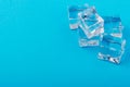 Ice cubes in close-up on blue background. top view Royalty Free Stock Photo