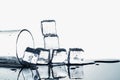 Ice cubes and empty glass on glossy table on white background Royalty Free Stock Photo