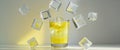 Ice Cubes Falling Into Glass of Refreshing Yellow Drink on Background Royalty Free Stock Photo
