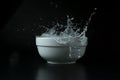 Ice cubes falling into white bowl on a black background stopped with high speed photography Royalty Free Stock Photo