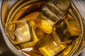 Ice cubes with a glass of amber whiskey, cognac or Bourbon. close-up, photo view from above