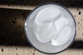 Ice cubes in a glass, top view with shadows