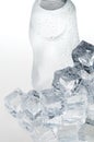 Ice cubes and mineral water bottle close-up Royalty Free Stock Photo