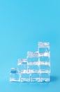Ice cubes with pastel blue background