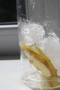 Ice cubes and pieces of lemon in a glass