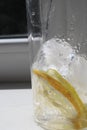 Ice cubes and pieces of lemon in a glass