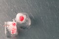 Ice cubes with red currant, on wooden background Royalty Free Stock Photo