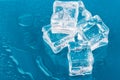 Ice cubes and water drops close up on blue background Royalty Free Stock Photo