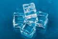 Ice cubes and water drops close up on blue background Royalty Free Stock Photo