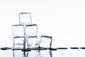 Ice cubes on glossy table on white background Royalty Free Stock Photo