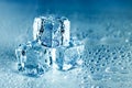 Ice cubes and water melt on cool background. Ice blocks with cold drinks or beverage