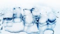 Ice cubes on white glass mirror background with reflection close up top view, transparent frozen crushed blue ice cubes Royalty Free Stock Photo