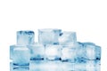 Ice cubes on white glass mirror background with reflection isolated close up, transparent frozen and melted crushed blue ice cubes Royalty Free Stock Photo