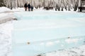 Ice cut into blocks for the construction of an ice town. Ice bricks lie on wooden props.