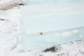 Ice cut into blocks for the construction of an ice town. Ice bricks lie on wooden props.